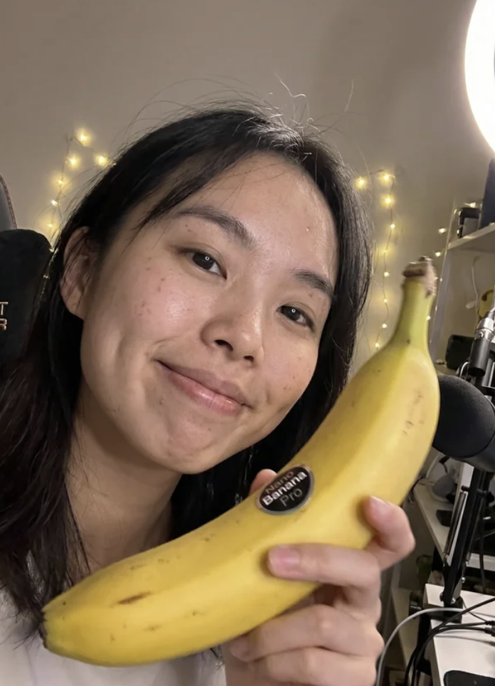 An AI-generated portrait of a young woman holding a banana in front of ring lights, an example of the synthetic creator-style content now flooding Facebook video feeds. The image is realistic at a glance but contains subtle inconsistencies of the kind covered in this post's seven detection signs.